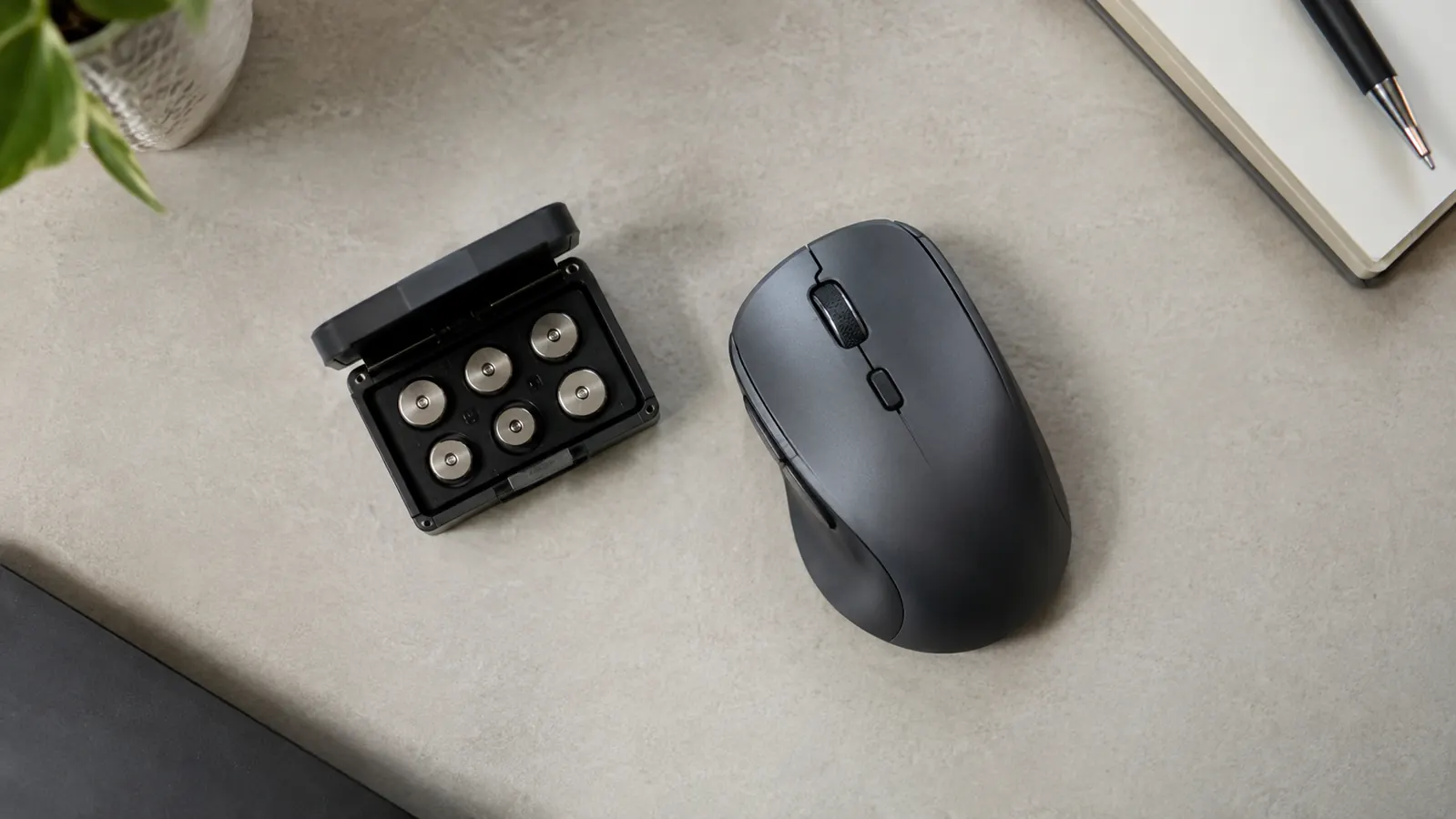 A wired gaming mouse on a desk next to an open compartment with small tuning weights
