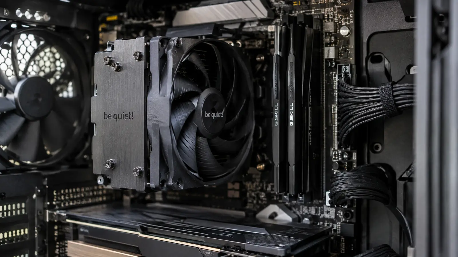 The CPU cooler installed in the PC, seen through the open side panel with motherboard and cables around it.